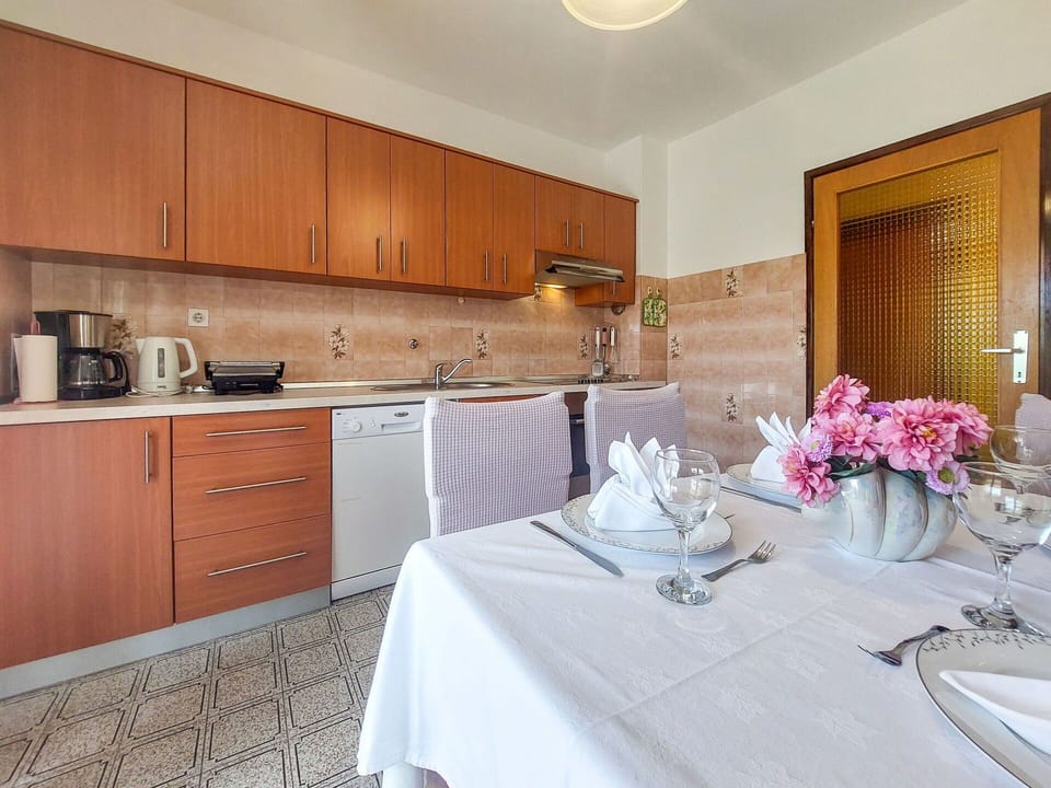Flooring, Interior Design, Furniture, Floor, Countertop, Room, Kitchen & Dining Room Table, Cabinetry, Chair, Kitchen