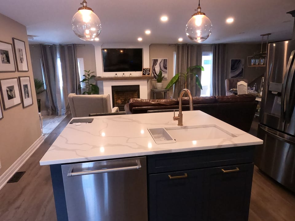 Calcutta countertops and gold fixtures in the gourmet kitchen.