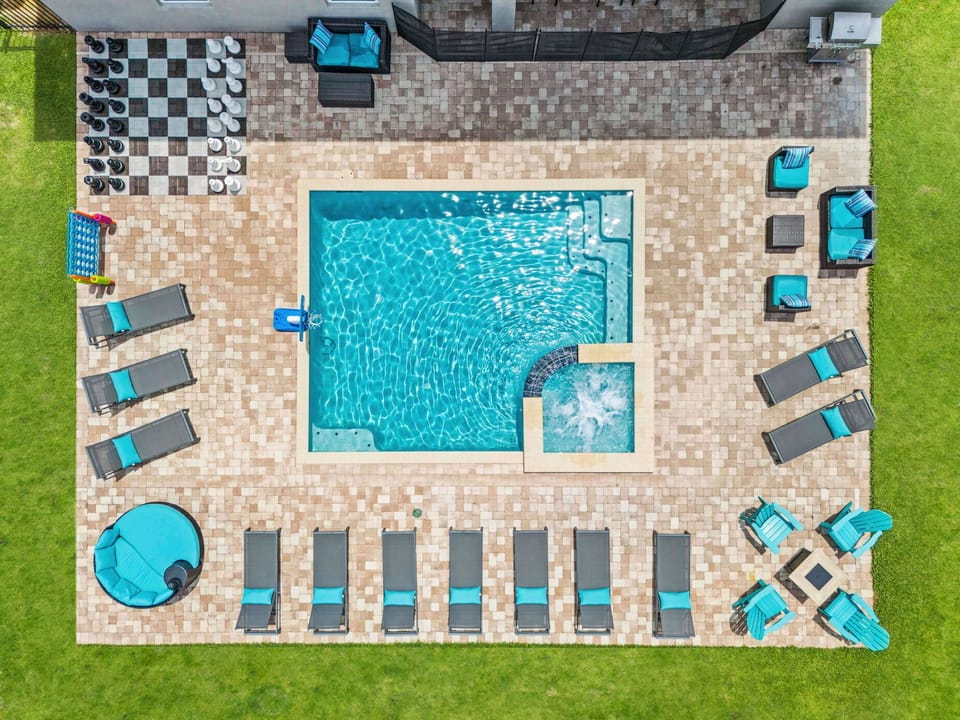 Step into the back yard for your own private pool and spillover spa