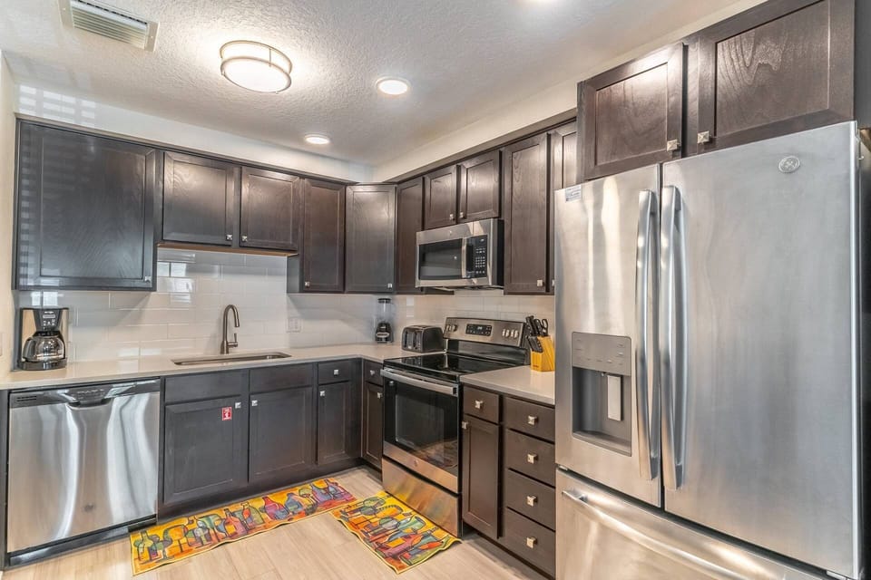 Fully stocked, modern and clean kitchen with stainless steel appliances