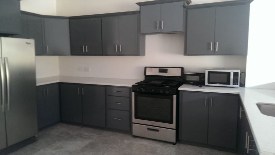 Spacious and fully furnished kitchen with stainless steel appliances.