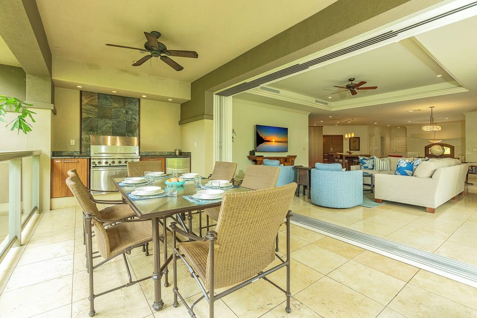 Your spacious open-plan living area flows seamlessly from the outdoor dining terrace to the living room and kitchen, perfect for entertaining or relaxing in tropical comfort.