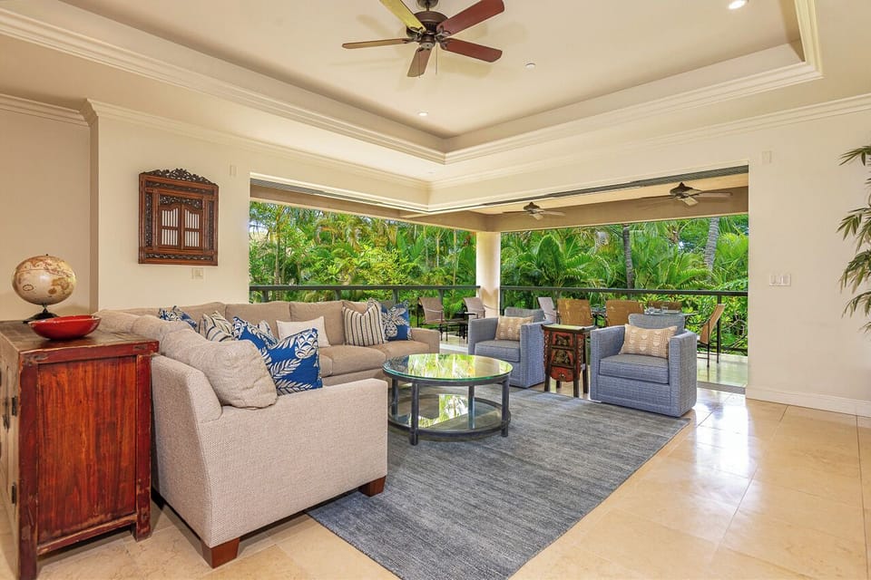 Sink into plush seating as tropical breezes drift through your open-air living room, where lush garden views frame every moment of your stay.
