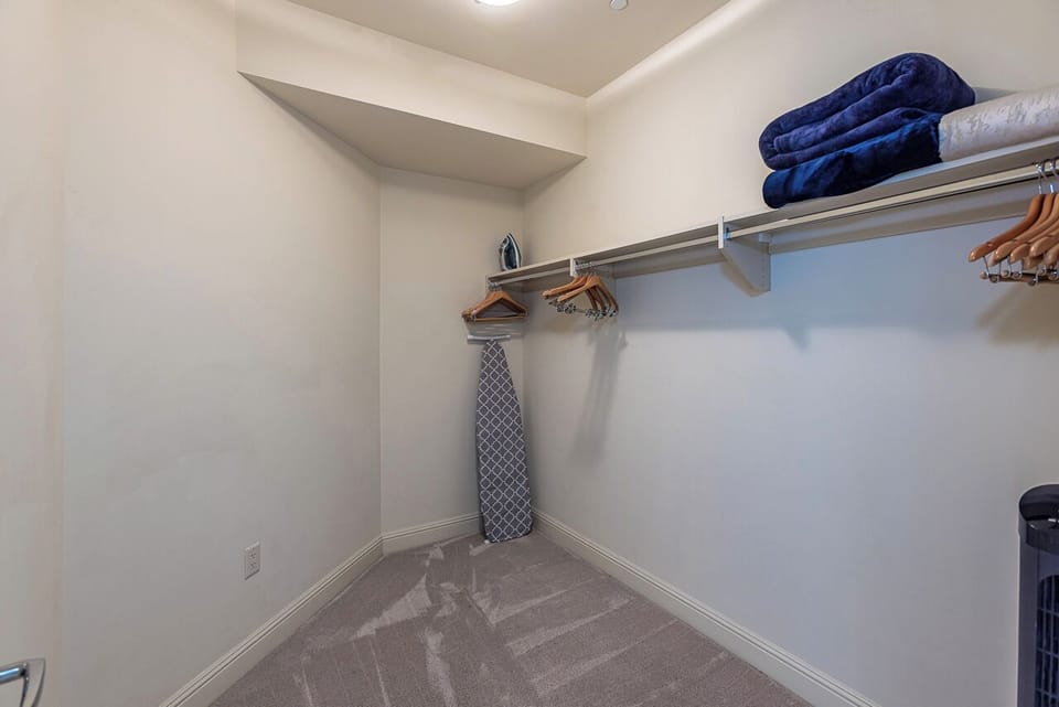 A spacious walk-in closet gives you ample room to unpack and settle in, with dedicated hanging space and shelving to keep your wardrobe organized during your stay.