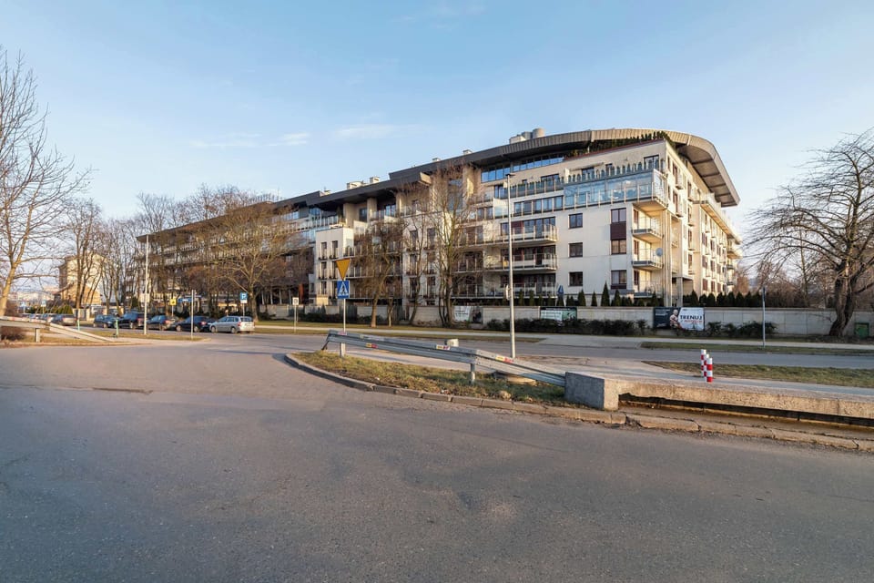 The building's entrance is sleek and modern, with secure entry points and clean landscaping.