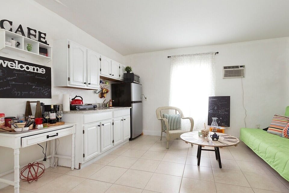 Microwave can be seen on top of the refrigerator.