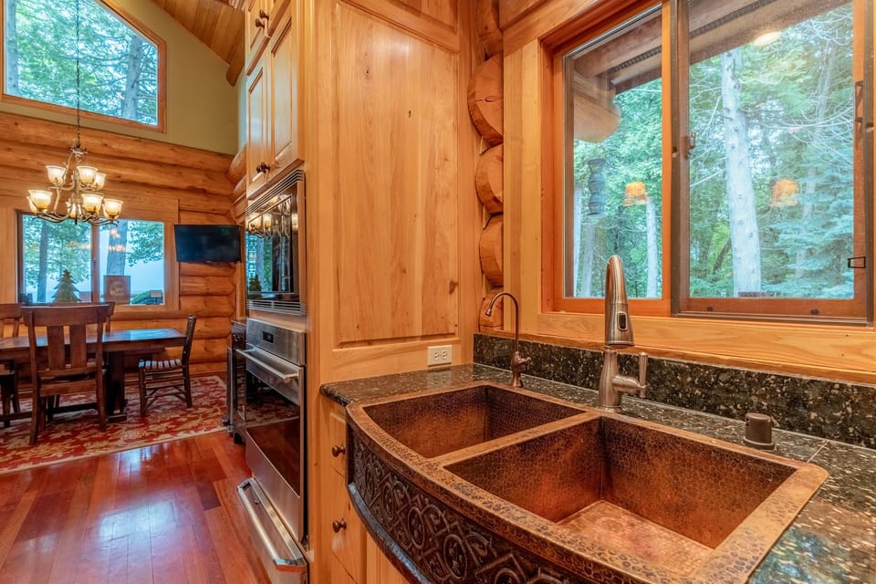 Custom kitchen with granite counters and a handmade copper sink