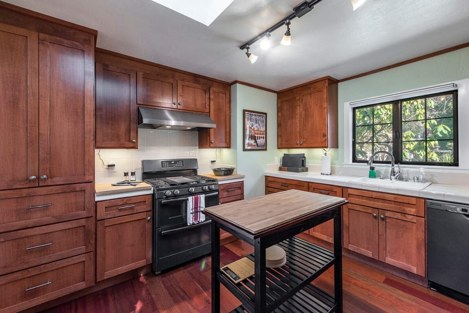 Well-stocked kitchen with dishwasher and propane range.