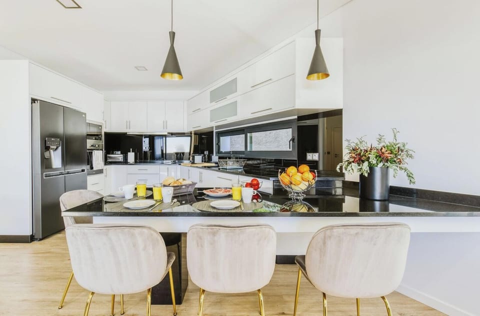 Open-space kitchen seamlessly connected to the living area, fully equipped for comfort and style—perfect for cooking, dining, and socializing in a modern luxury setting. #OpenSpaceLiving #ModernKitchen #VillaBelmonte