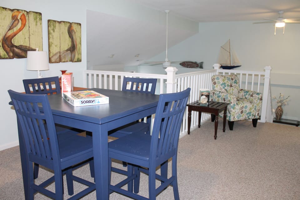 View of 2nd floor loft with reading chair and table