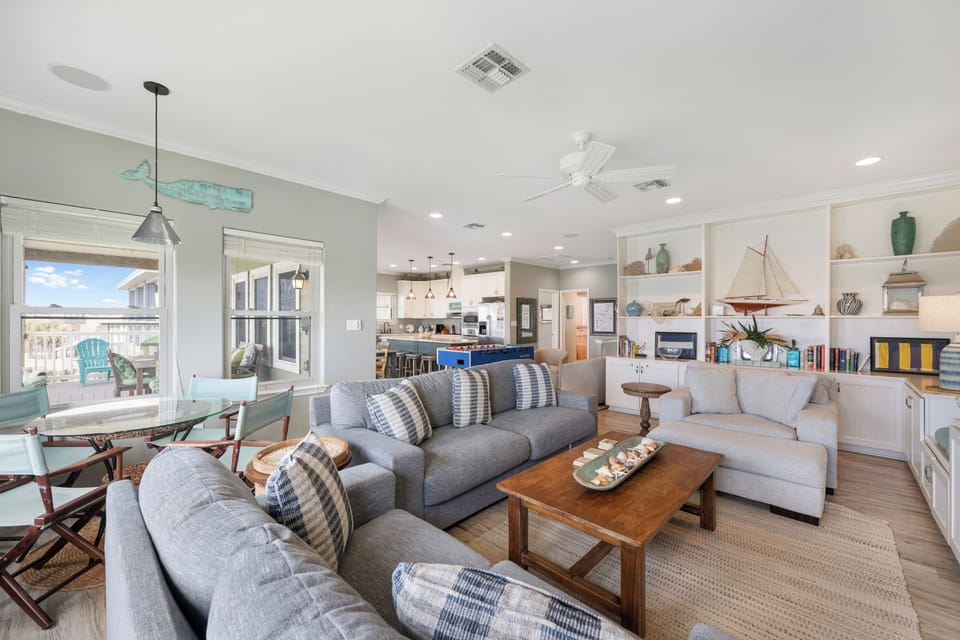 Sink into your coastal living room's plush sectional and admire nautical touches while natural light streams through windows overlooking your private balcony.