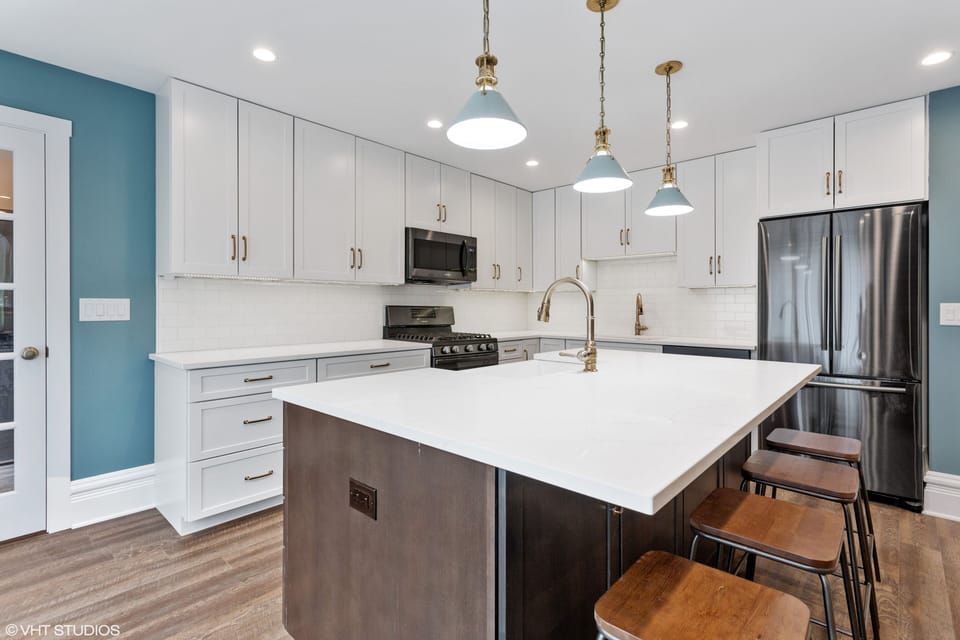 Kitchen nicely designed with Quartz countertops and Black Stainless Appliances
