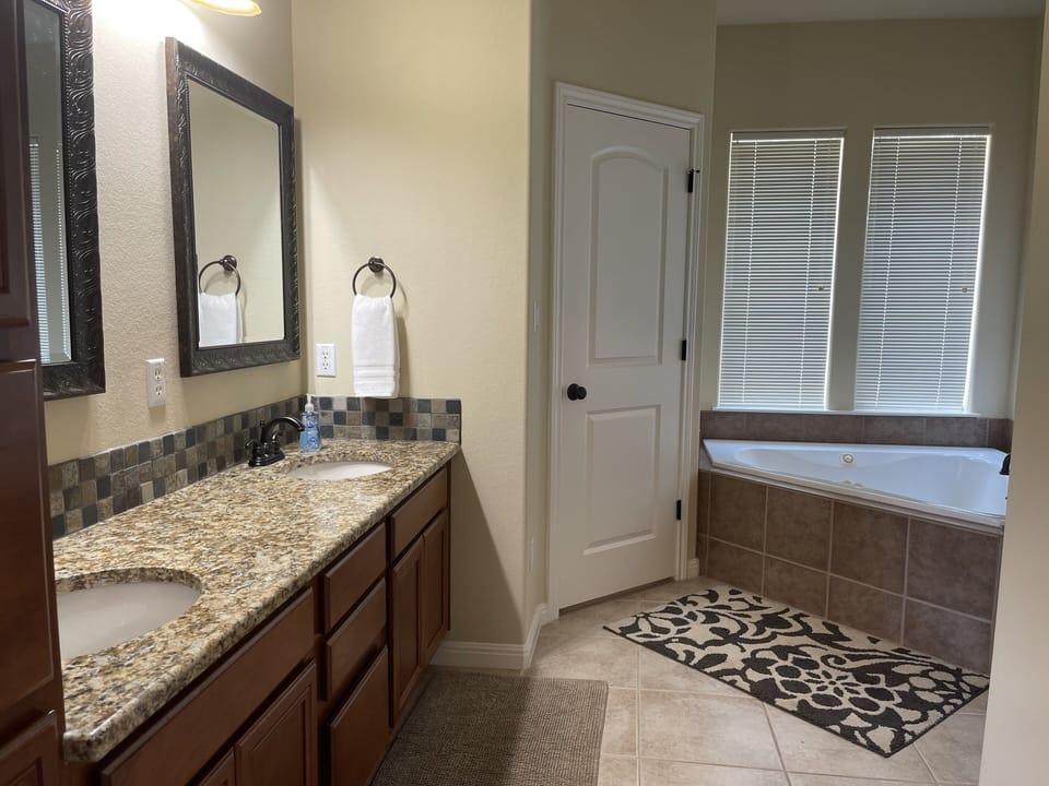 Main bathroom with separate shower and jacuzzi tub.