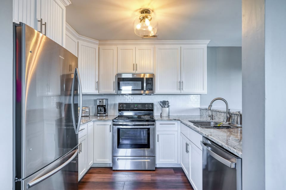 Renovated kitchen w/ new appliances and fully stocked for all cooking needs.