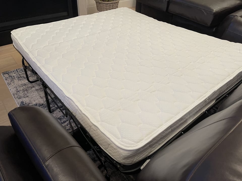 Sleeper sofa with upgraded memory foam mattress and complete bedding set. 