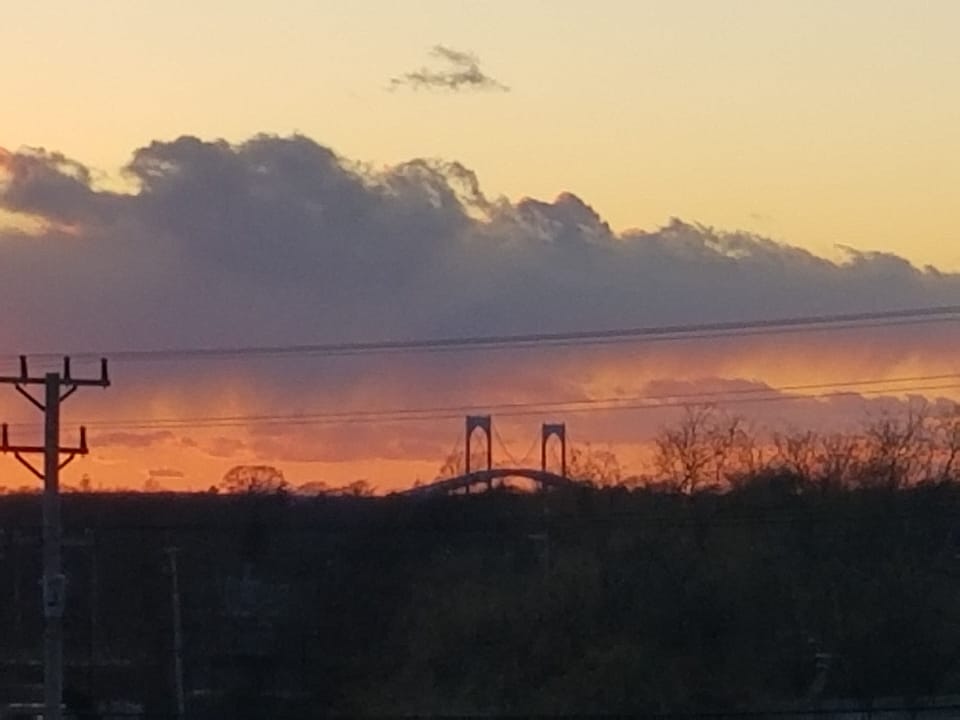 view of the sun setting over the bridge