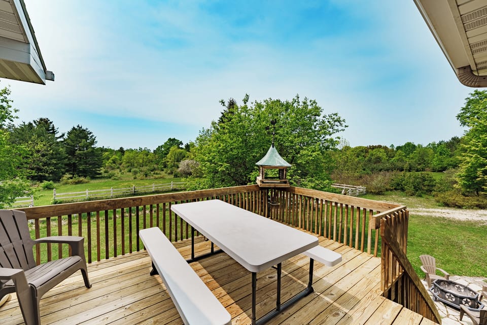 First floor patio overlooking the beautiful property w/ access to fire pit