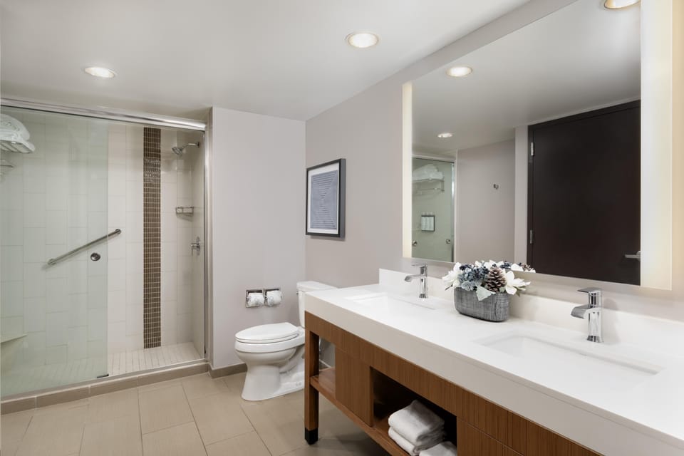 Deep soaking tub, hydromassage showerhead, designer toiletries
