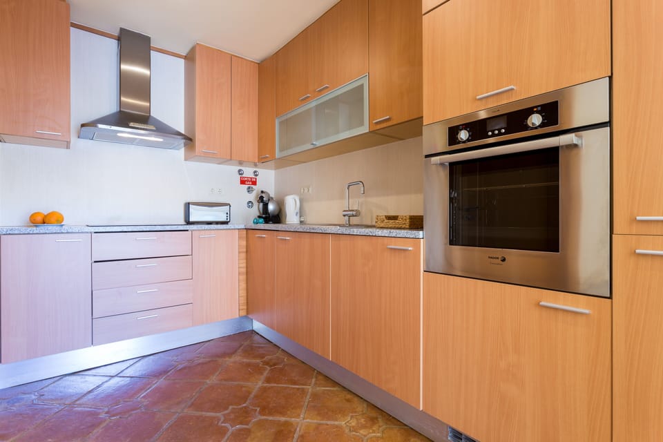 Separate well-equipped kitchen located beside the living room. 