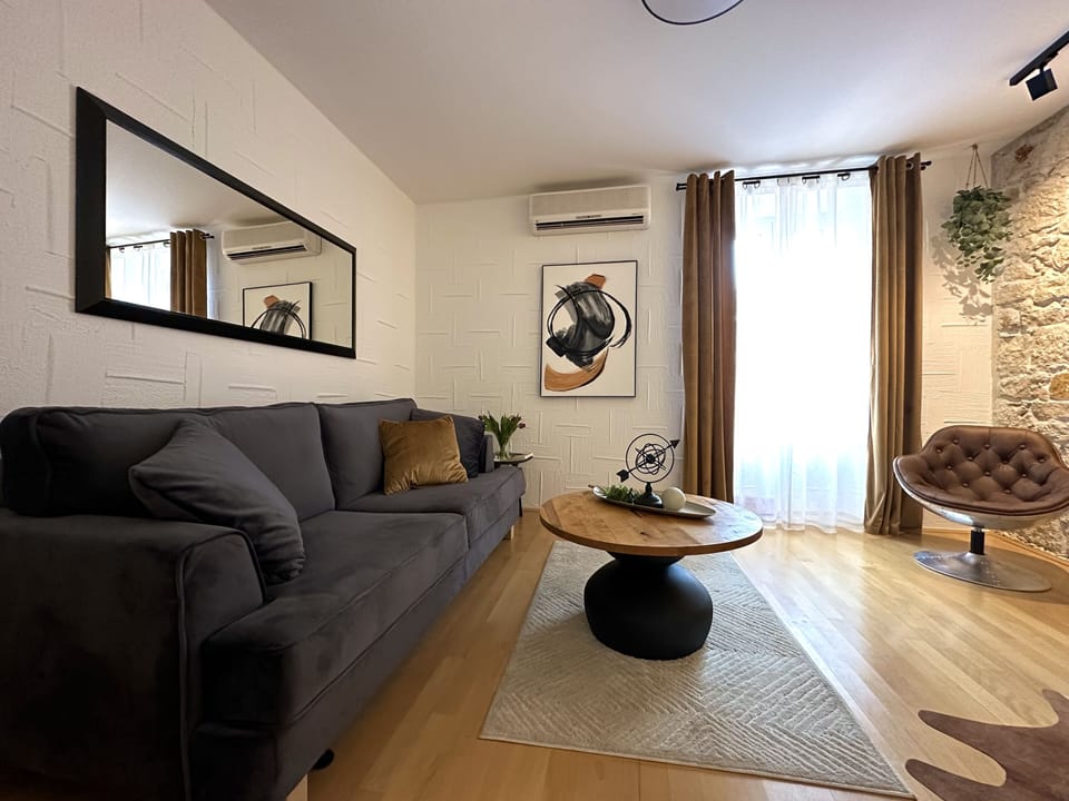 Standard Apartment | Living area | 100-inch TV with satellite channels