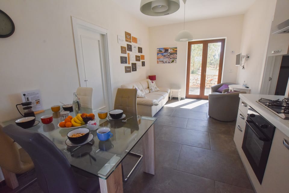 Living room with kitchen, dining table, and seating area