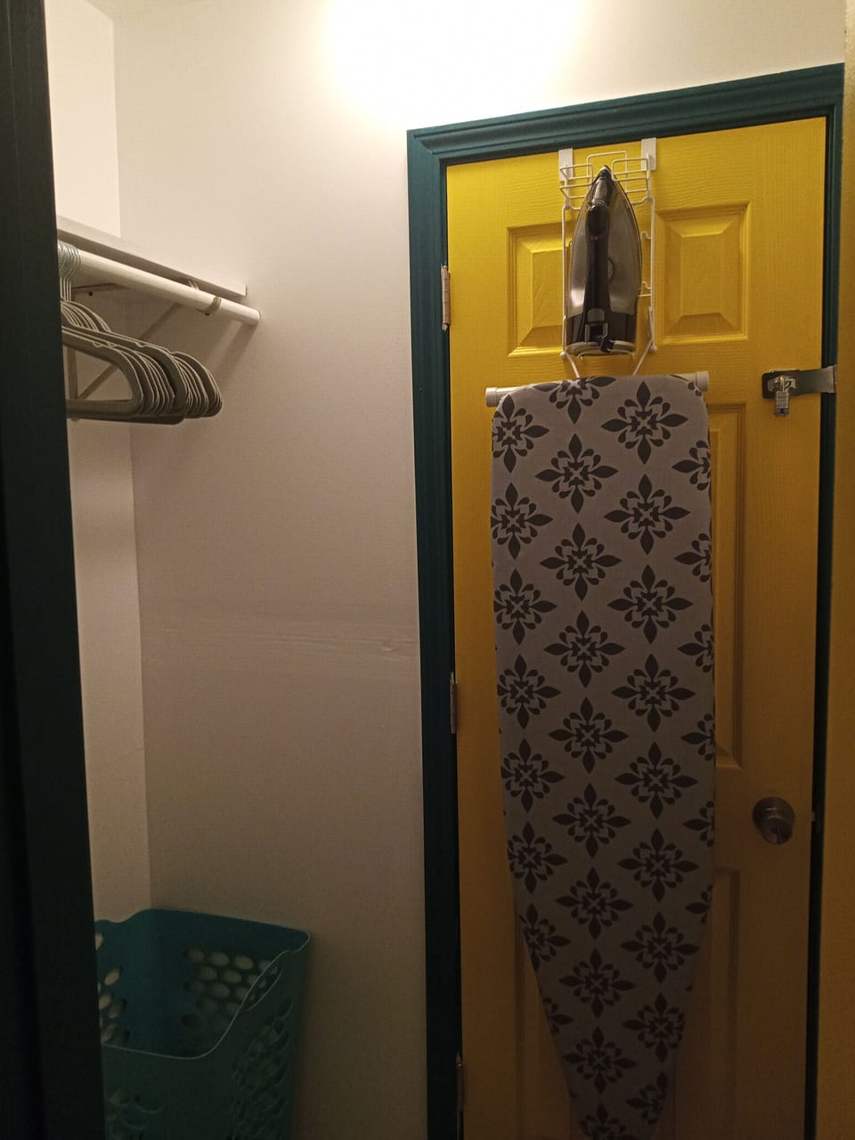 CLOSET SPACE WITH IRON AND IRONING BOARD