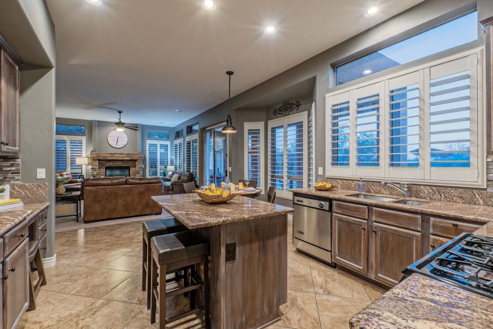 The many large windows illuminate the back of the home and provide stellar views of the backyard oasis.