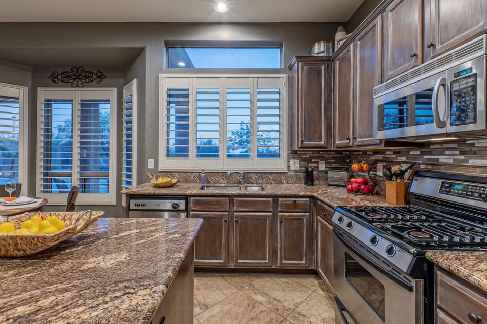 The modern kitchen has an island and ample counter space for preparing and serving a feast.