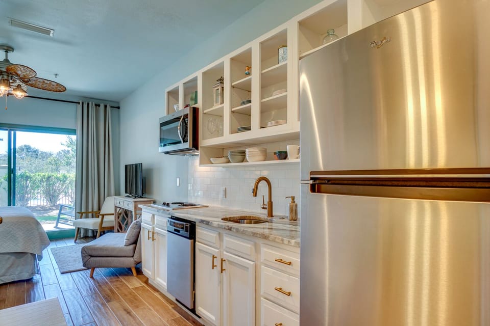 Your fully equipped kitchen features marble countertops, stainless steel appliances, and elegant brass fixtures perfect for preparing meals.