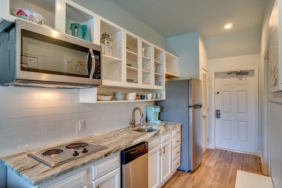Cook your favorite meals in this bright, fully-equipped kitchen featuring modern appliances and ample storage for all your vacation needs.