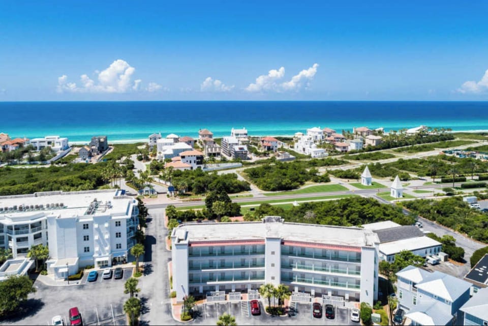 Aerial view of beachfront property showcasing stunning turquoise waters and pristine white sand beach just moments away from your accommodation.