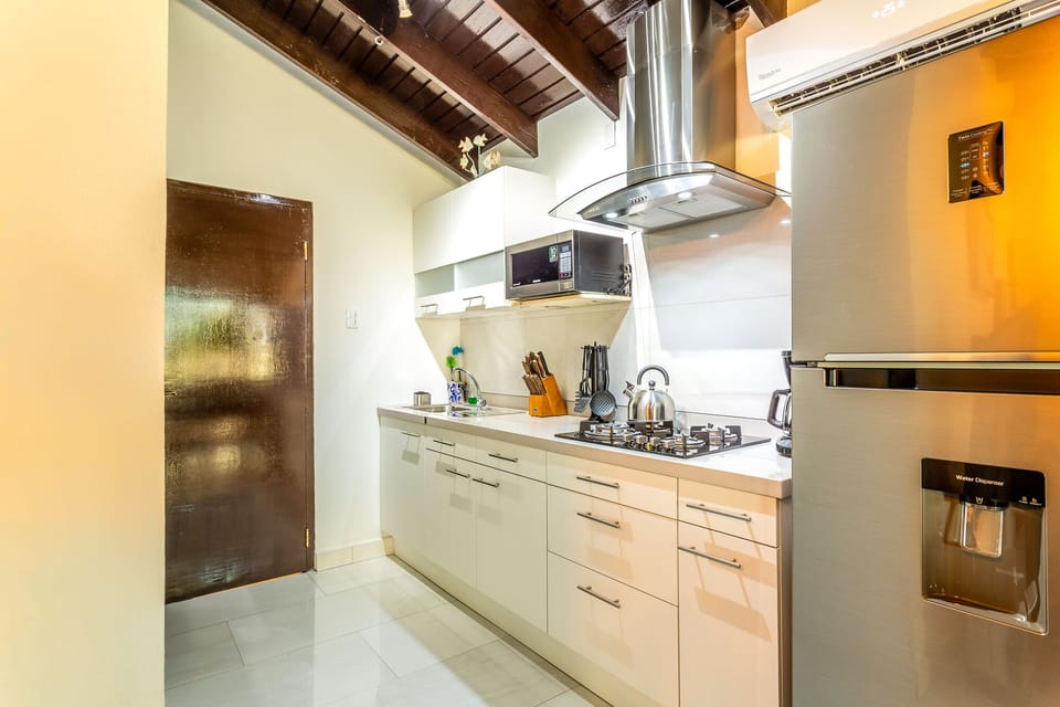 Spacious Kitchen area of Apartment in Marina - Fully equipped with kitchen Accessories - Smart use of space with versatile storage solutions -  Sleek stainless-steel appliances