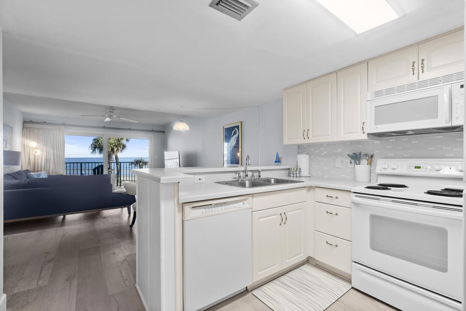 Bright, open kitchen flowing into cozy living area for relaxing stays