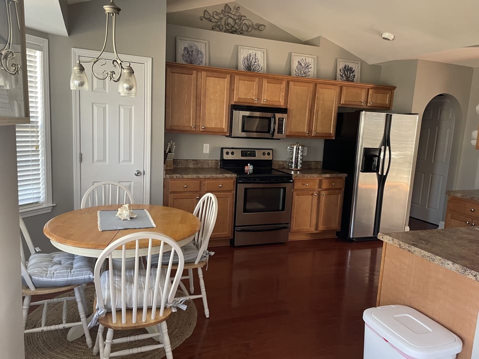 Kitchen equipped with family size refrigerator, freezer, microwave, oven.