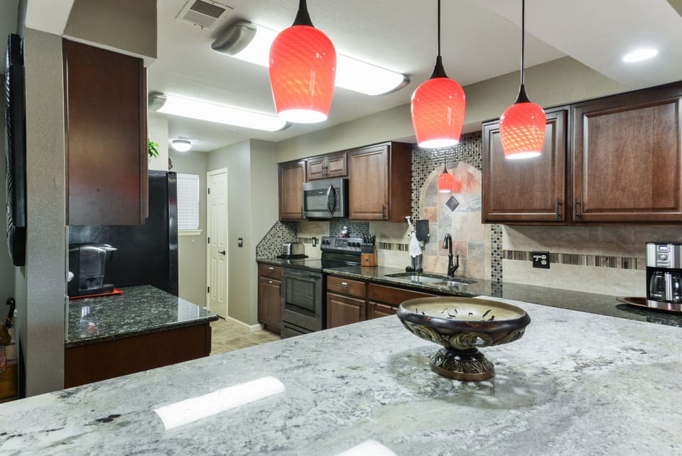 Well Stocked KItchen, granite counters, stainless appliances, tile floors.