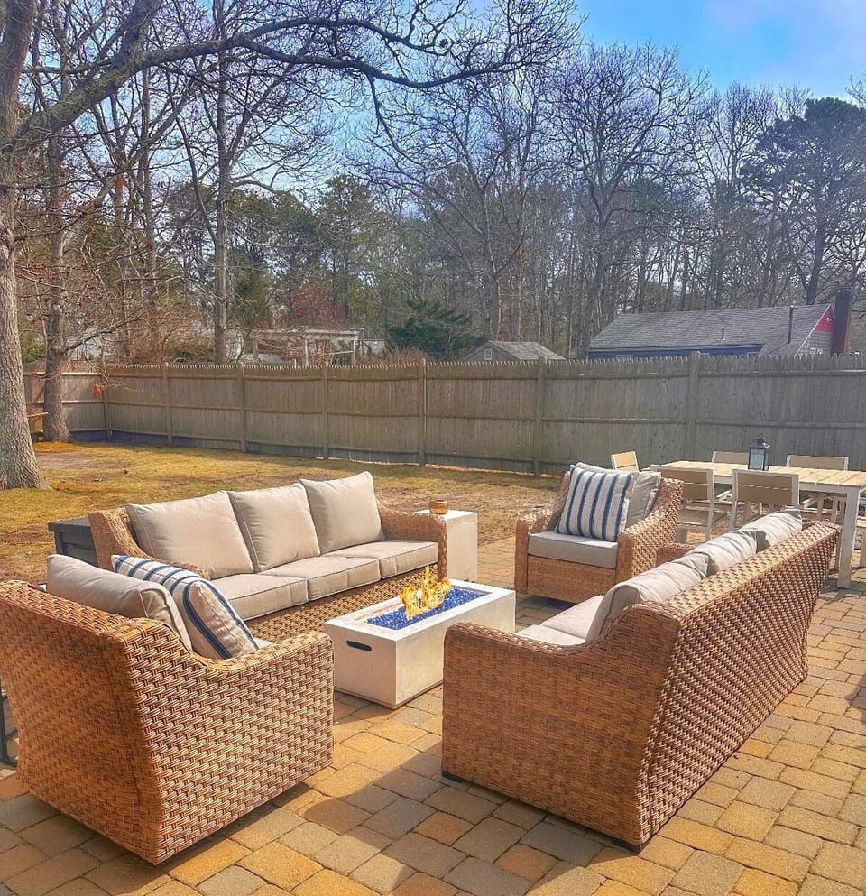 Fully fenced in Backyard w/ outdoor seating, outdoor dining and propane firepit