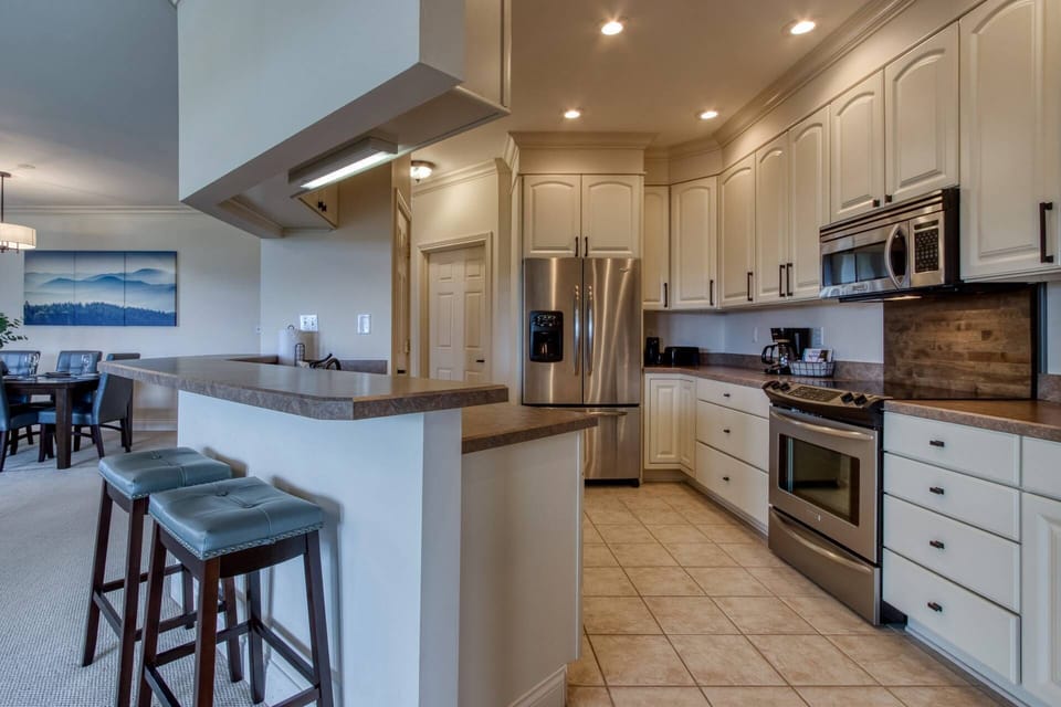 Open concept kitchen with eat-in bar allows for easy conversation while preparing meals