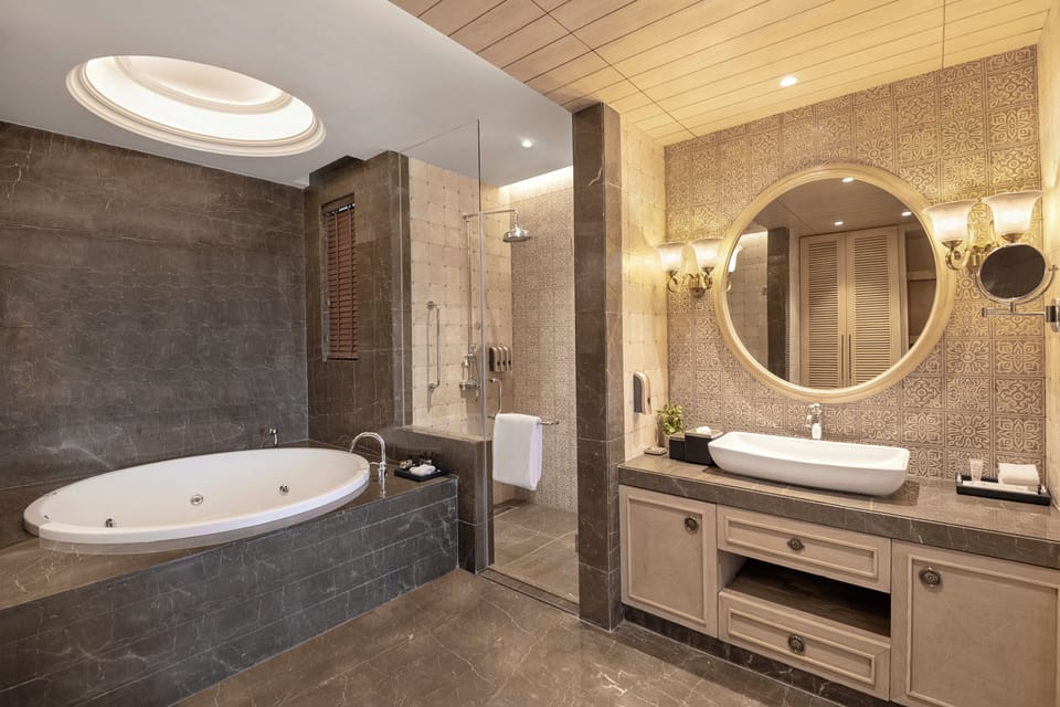 Deep soaking tub, designer toiletries, hair dryer, bathrobes