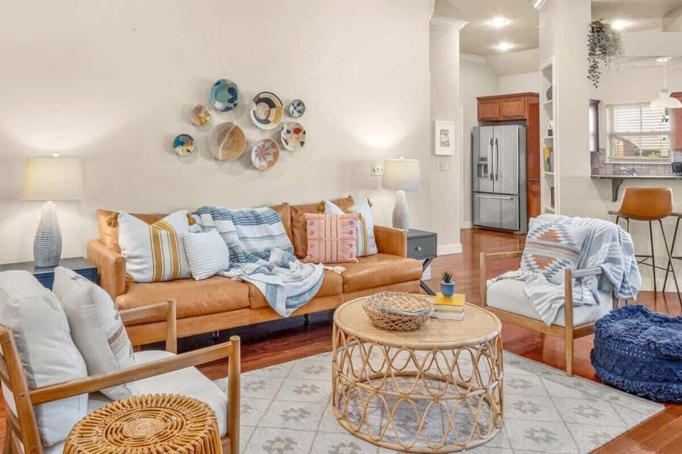 Cozy living room with comfy couch and chairs with lamps and coffee table.