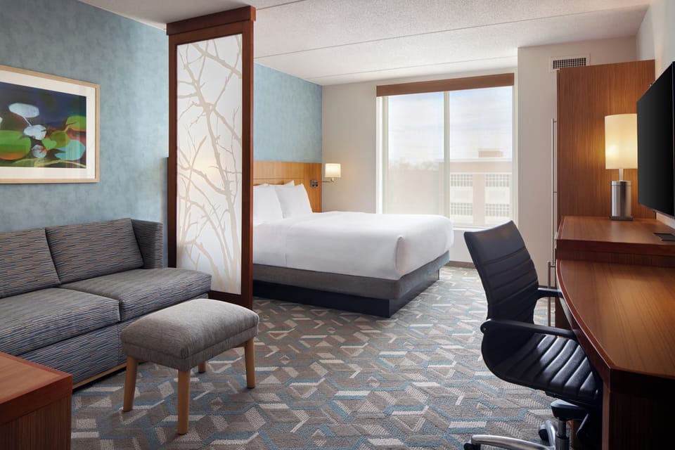Premium bedding, desk, laptop workspace, blackout drapes