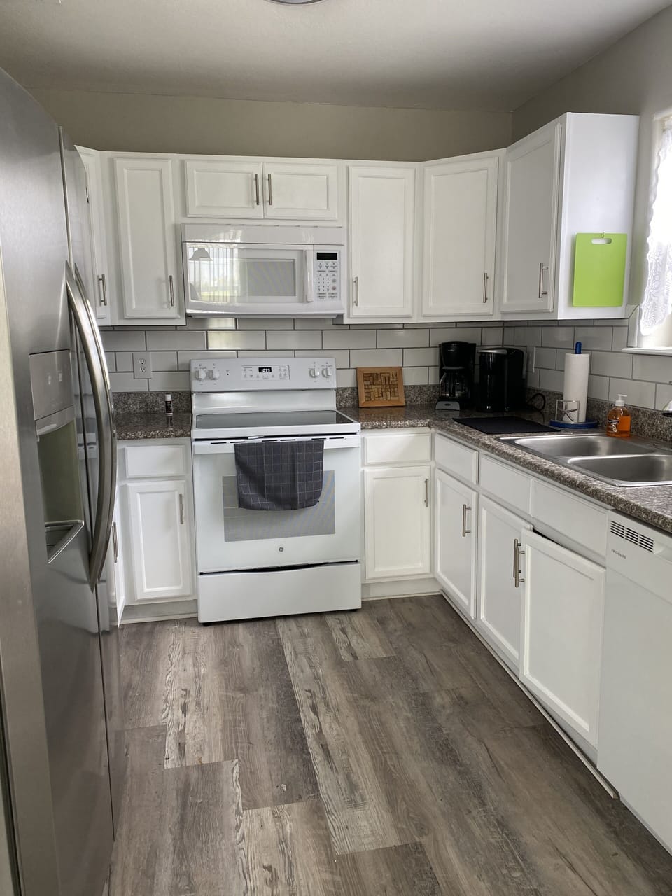 Fully stocked kitchen with new glass top stove, microwave, dishwasher, ss fridge