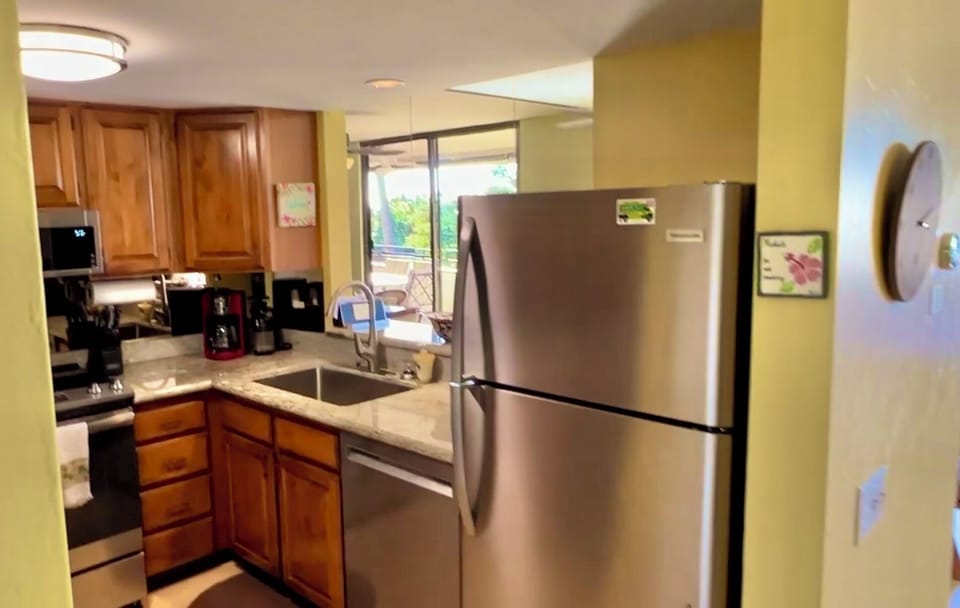 Bright fully stocked Kitchen. Ample counter space. All that you need to dine in!