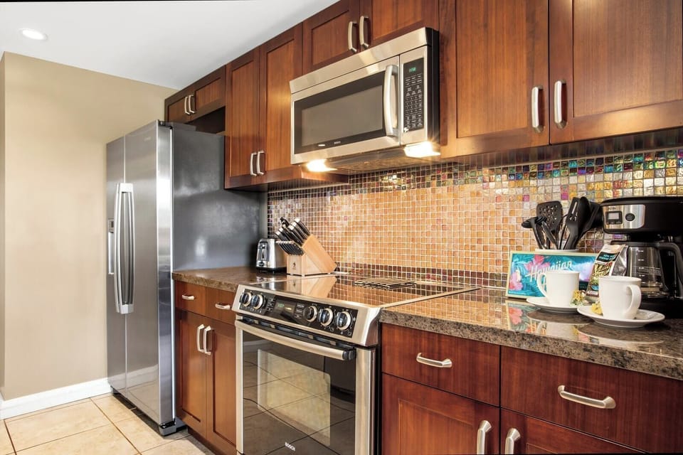 Warm-toned kitchen with modern appliances and tropical coffee station setup.