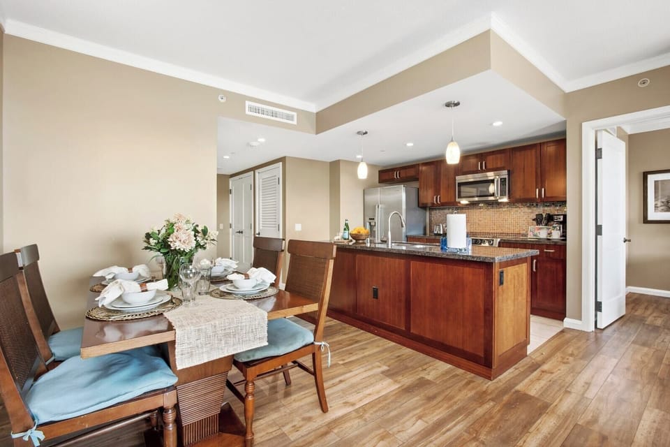 Modern kitchen and dining area with elegant wood and lighting.