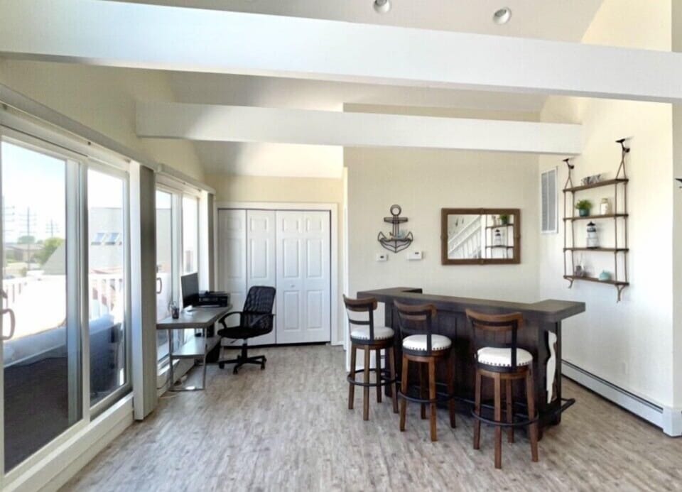 Game room - bar and work area. Mini fridge behind bar.