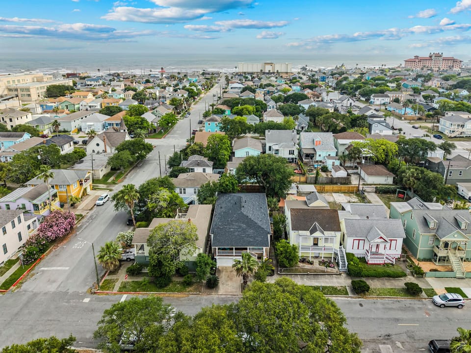 A bird's-eye view of the neighborhood around 1703 Avenue M — classic Galveston streetscapes with the beach close by.