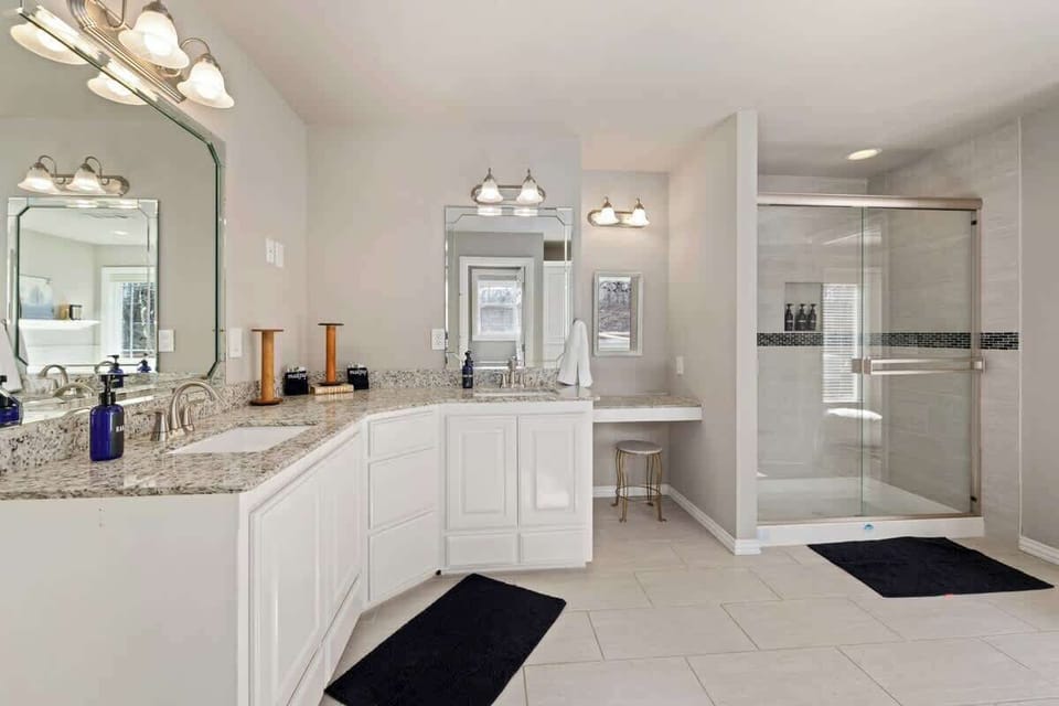 In addition to the jacuzzi tub, this bathroom has a large vanity + spacious walk-in shower.