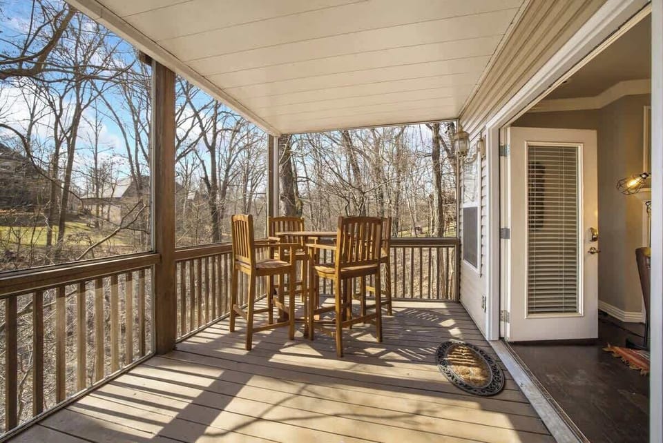 Located right off the downstairs living room is our screened-in porch, complete with a bar height table!