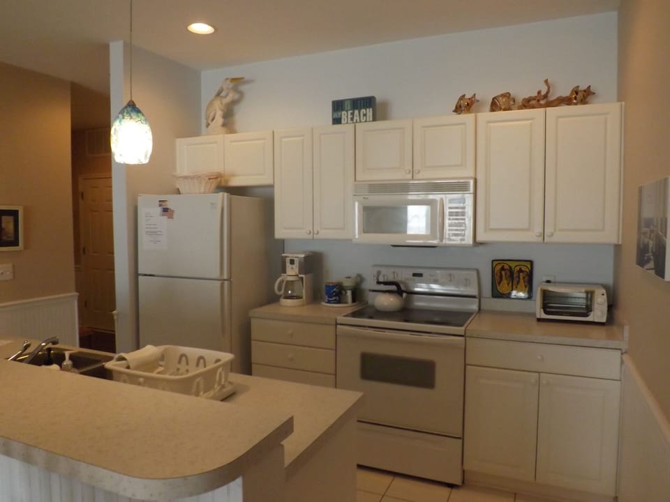 Kitchen, with oven, microwave, toaster oven, coffee pot, frig w / ice maker