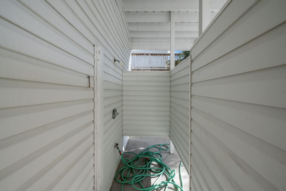 Rinse away the sand in the out door shower.